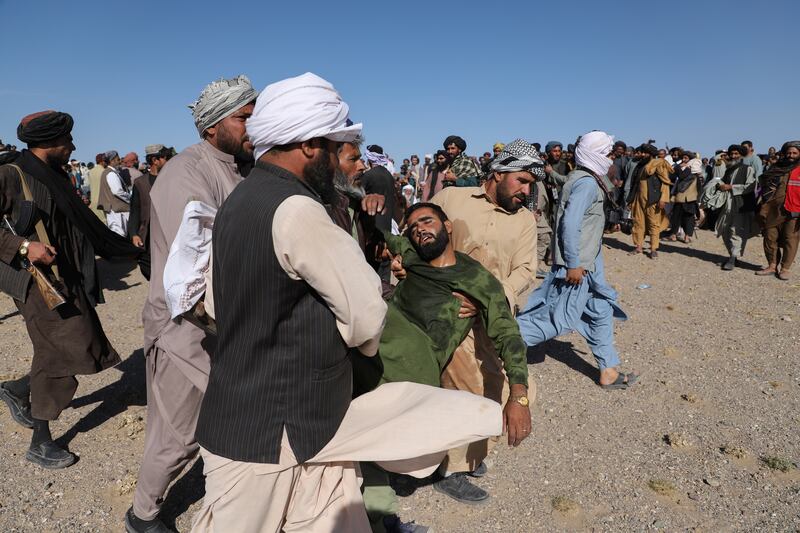 A relative of earthquake victims faints after seeing dead bodies in Sia Ab village, Herat, Afghanistan. Mahab Azizi for The National