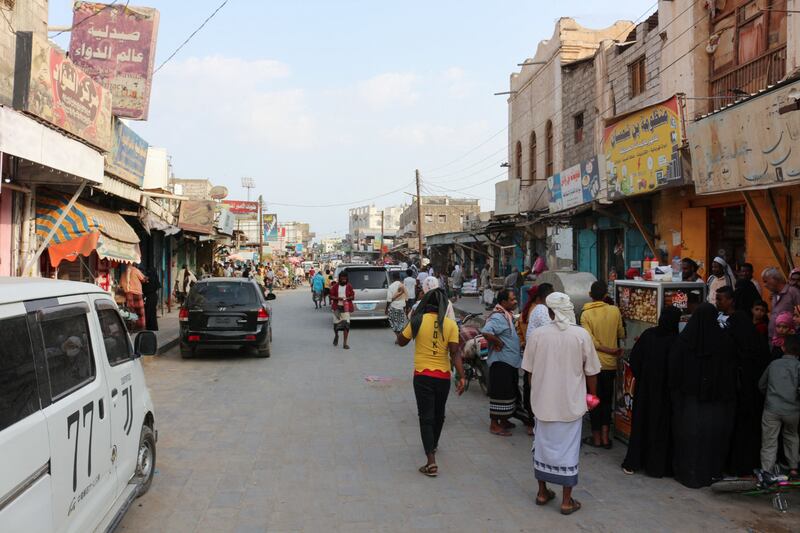 People walk on a market street in the southern Yemeni city of Lahj.