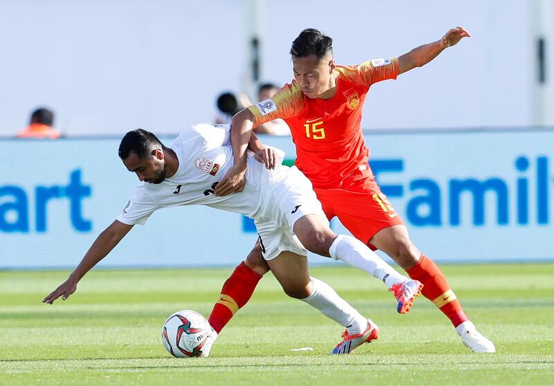 Kyrgyzstan's midfielder Akhlidin Israilov, left, and China's defender Wu Xi fight for the ball. AP Photo