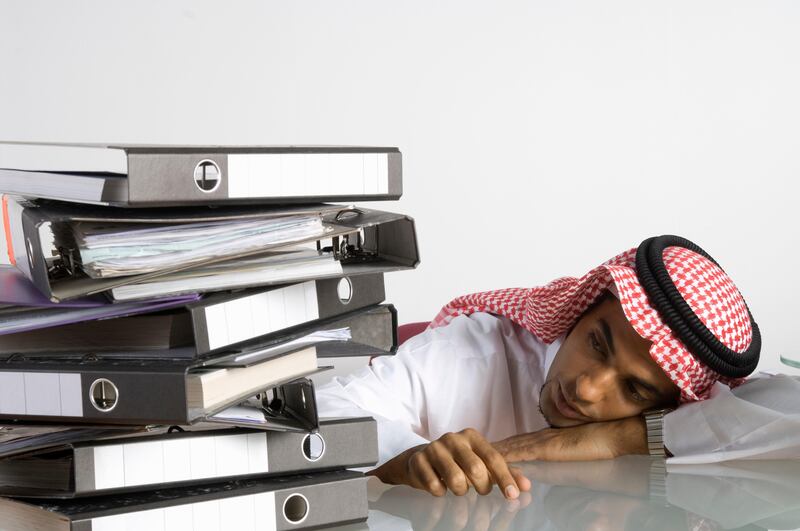 Young Arab man sitting with a lot of files (Getty Images) *** Local Caption ***  hl23ma-ramadan-sleep.jpg