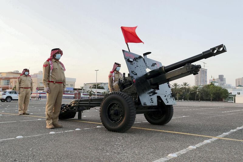 DUBAI, UNITED ARAB EMIRATES , April 24– 2020 :- Dubai Police officer getting ready to fire the cannon on the first day of Ramadan to break the fast at the Al Mankhool area in Dubai.  (Pawan Singh / The National) For News/Standalone/Online/Instagram. 