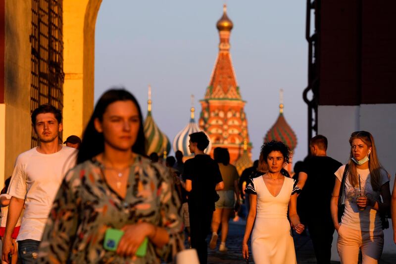 People walk in Red Square, Moscow, at sunset. A plan to vaccinate 30 million people in Russia by mid-June against the coronavirus has fallen short by a third and daily new infections have surged. AP