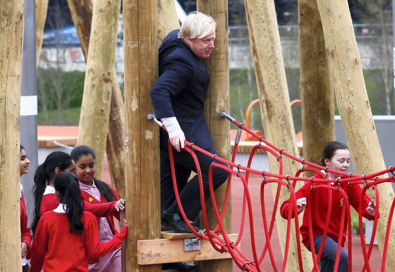 Mayor of London Boris Johnson squeezes onto a children's play rope bridge when he and Prince Harry (not pictured) viewed the Queen Elizabeth Olympic Park ahead of its opening on Saturday at Stratford in east London April 4, 2014.  REUTERS/Luke MacGregor  (BRITAIN - Tags: ROYALS ENTERTAINMENT POLITICS SPORT)