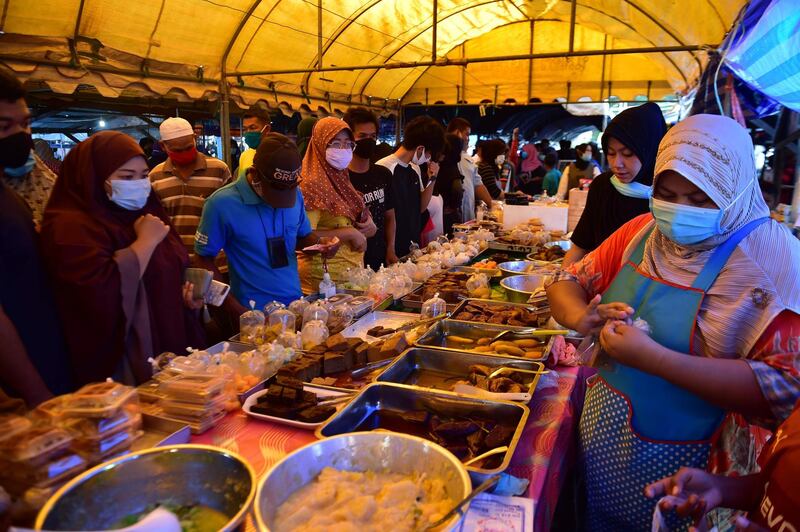 People shop at a food market on the first day of the Muslim holy month of Ramadan in Thailand's southern province of Narathiwat.  AFP