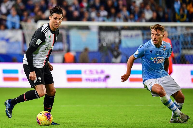 Juventus' Portuguese forward Cristiano Ronaldo (L) is marked by Lazio's Italian forward Ciro Immobile. AFP