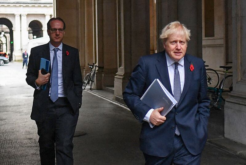 In this file picture taken on November 10, 2020, UK Prime Minister Boris Johnson and Martin Reynolds, the Prime Minister's Principal Private Secretary, arrive back at Downing Street in London. AFP