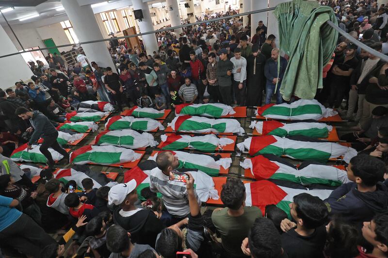 Palestinian mourners surround the bodies of people who died when fire broke out in a flat in the Jabalia refugee camp in the northern Gaza strip. AFP
