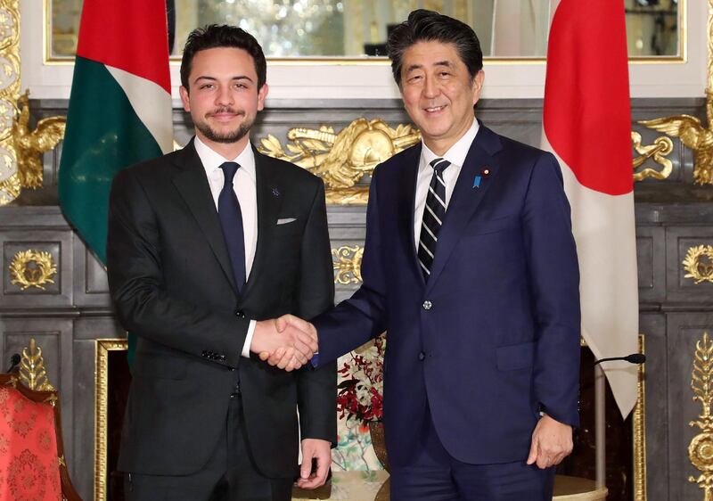 Japan's Prime Minister Shinzo Abe shakes hands with Crown Prince Hussein, the son of King Abdullah ll of Jordan, Tokyo.  AFP