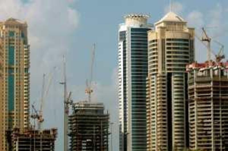 Cranes are erected at the man-made Palm Island in Dubai, where scores of skyscrapers and towers are under construction, on November 16, 2008. Stock markets in the Gulf states plunged on the week's opener today as panic from the fallout of the global economic crisis continued to dampen investor sentiment. The slump has affected the construction sector in Dubai with reports suggesting that many firms have begun cutting the number of their employees. AFP PHOTO/MARWAN NAAMANI