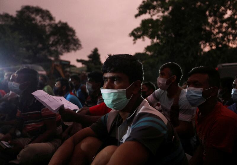 Bangladeshi migrant workers wait for their turn to have their documents checked in an effort to stop forced labour and human trafficking. Reuters