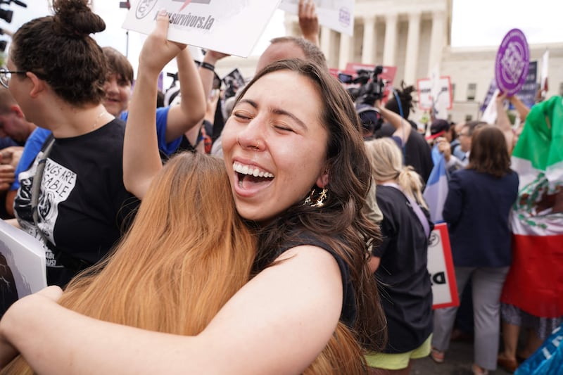 Pro-life supporters hug outside the court. AFP