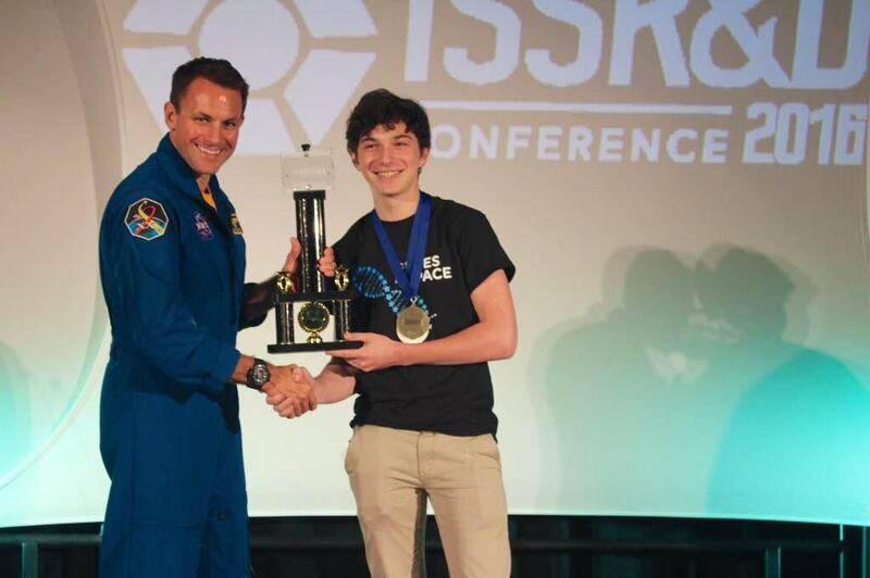 Julian Rubinfien receiving the Genes in Space trophy from astronaut Josh Cassada in San Diego last month. Courtesy Julian Rubinfien