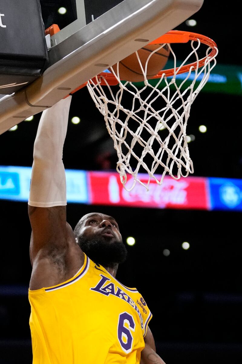 LeBron James dunks during the game against the Sacramento Kings in Los Angeles. AP