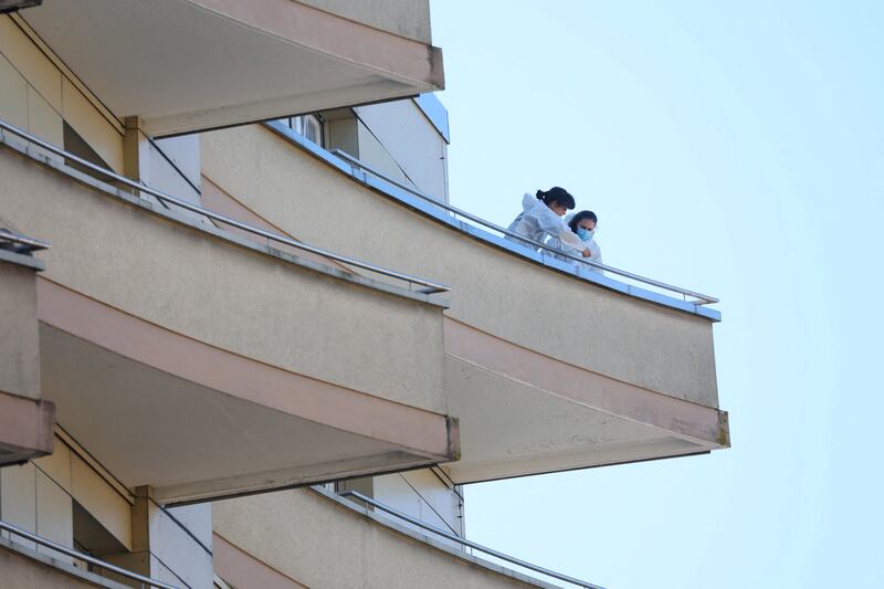 Forensics officers take samples on a balcony after five people appeared to have jumped from a seventh-floor apartment, in Montreux, Switzerland. Reuters