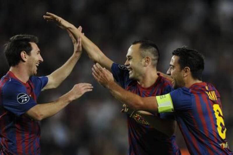 BARCELONA, SPAIN - OCTOBER 19:  Andres Iniesta of FC Barcelona (C) celebrates with his teammates Lionel Messi (L) and Xavi Hernandez after scoring the opening goal during the UEFA Champions League Group H match between FC Barcelona and FC Viktoria Plzen at Camp Nou on October 19, 2011 in Barcelona, Spain.  (Photo by David Ramos/Getty Images) *** Local Caption ***  129662694.jpg