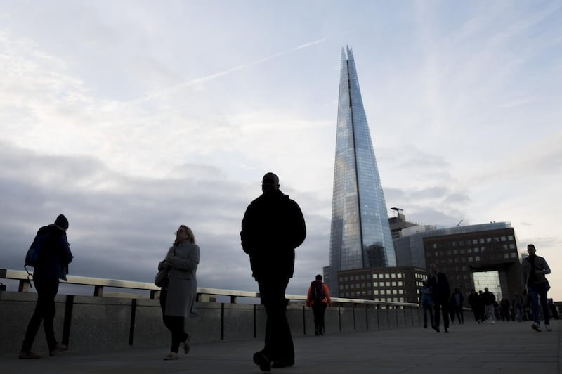 Commuters on their way into the City of London walk across London Bridge in view of The Shard in London, U.K., on Monday, Sept. 28, 2020. Londoners are looking for jobs outside the capital as the city struggles to generate new work after the coronavirus slump. Photographer: Jason Alden/Bloomberg