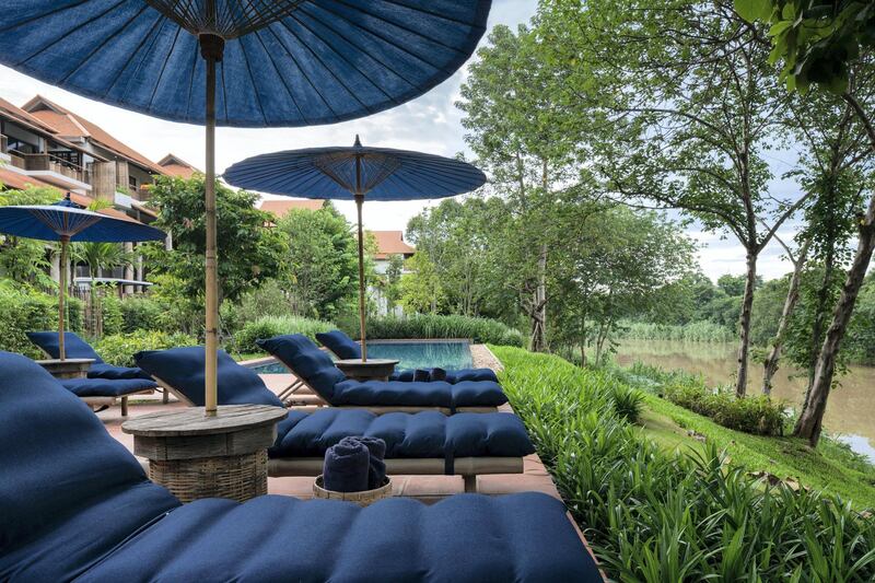 The pool area of the hotel, with the loungers dyed indigo using traditional Chiang Mai craftsmanship. Photo: Supplied 
