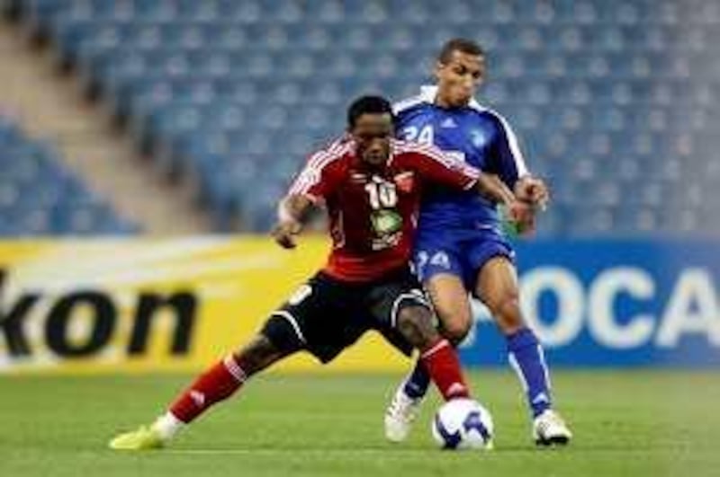Saudi al-Hilal's Mohammed al-Nakhli (back) vies for the ball with Emirati al-Ahli's Ahmed Khalil during their AFC Champions League group A football match in Riyadh on April 7, 2009. Hilal won the match 2-1. AFP PHOTO/MIDO AHMED