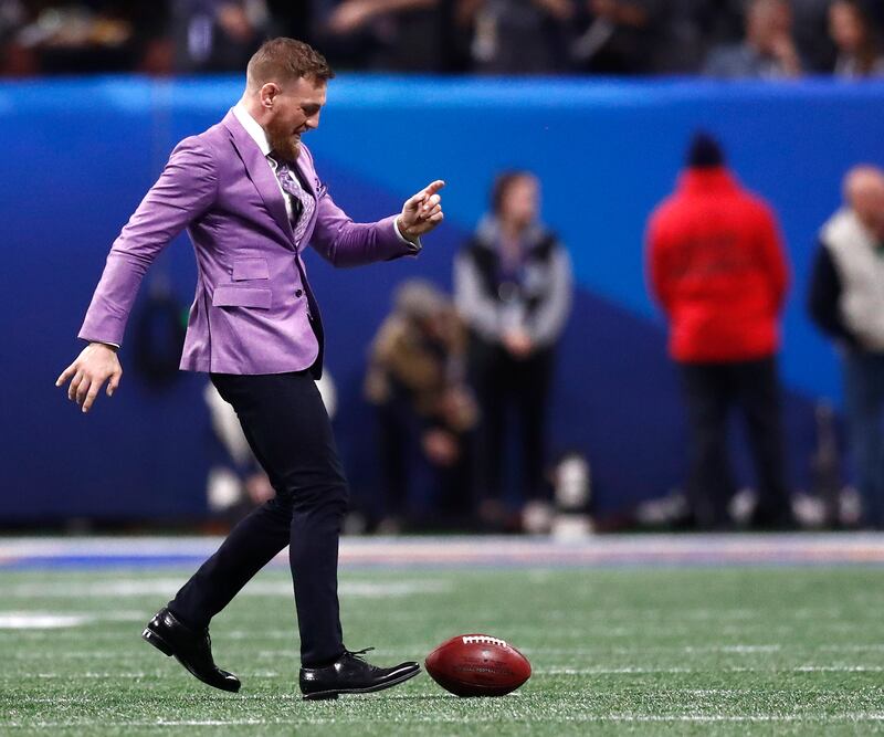 UFC fighter Conor McGregor kicks around a football on the field prior to the start of Super Bowl LIII between the New England Patriots and the Los Angeles Rams at Mercedes-Benz Stadium in Atlanta on February 3, 2019.
