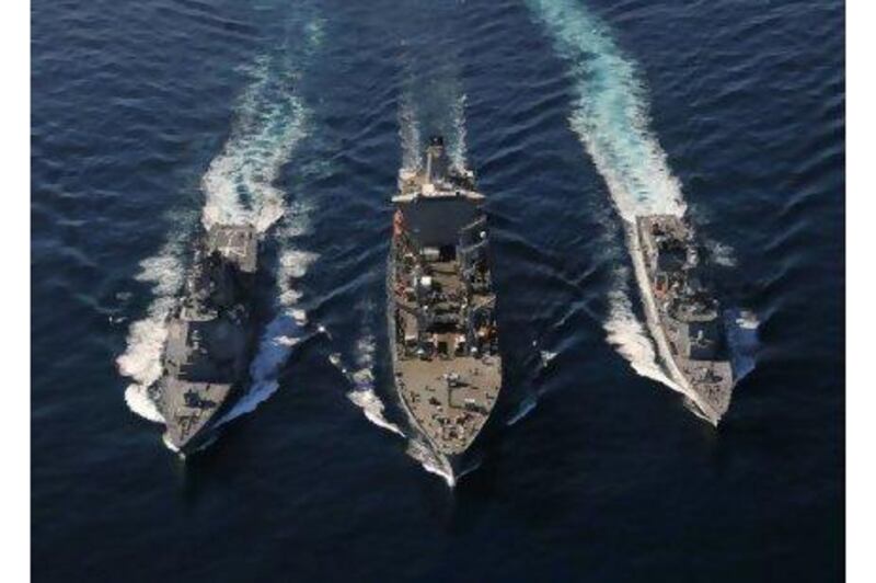 The USNS Tippercanoe, centre, refuels Japanese destroyers during military manoeuvres in the Pacific Ocean on Sunday.
US Navy Spc 3rd Class Charles Oki / Reuters