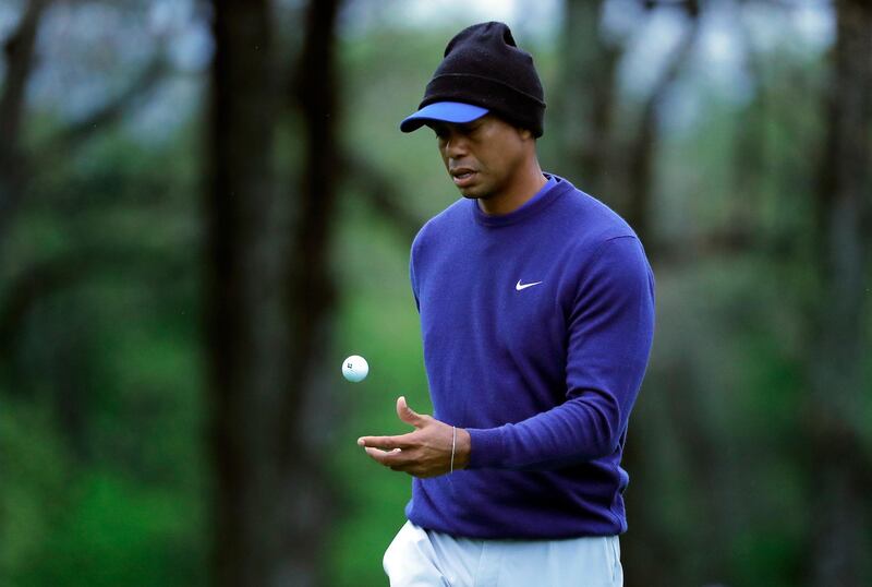 Tiger Woods flips his ball as he walks along the ninth green during a practice round for the PGA Championship golf tournament, Monday, May 13, 2019, in Farmingdale, N.Y. (AP Photo/Julie Jacobson)