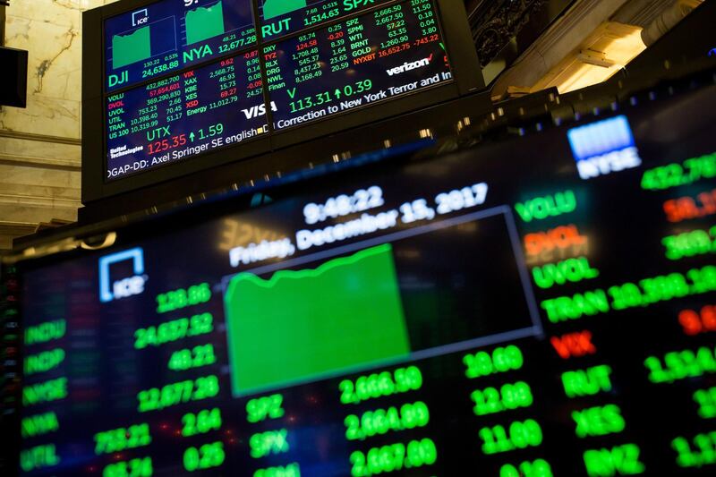 Monitors display stock information on the floor of the New York Stock Exchange (NYSE) in New York, U.S., on Friday, Dec. 15, 2017. U.S. stocks gained with the dollar as investors assessed messages from the Federal Reserve and European Central Bank meetings this week with concerns lingering about the prospects for U.S. tax overhaul. Photographer: Michael Nagle/Bloomberg