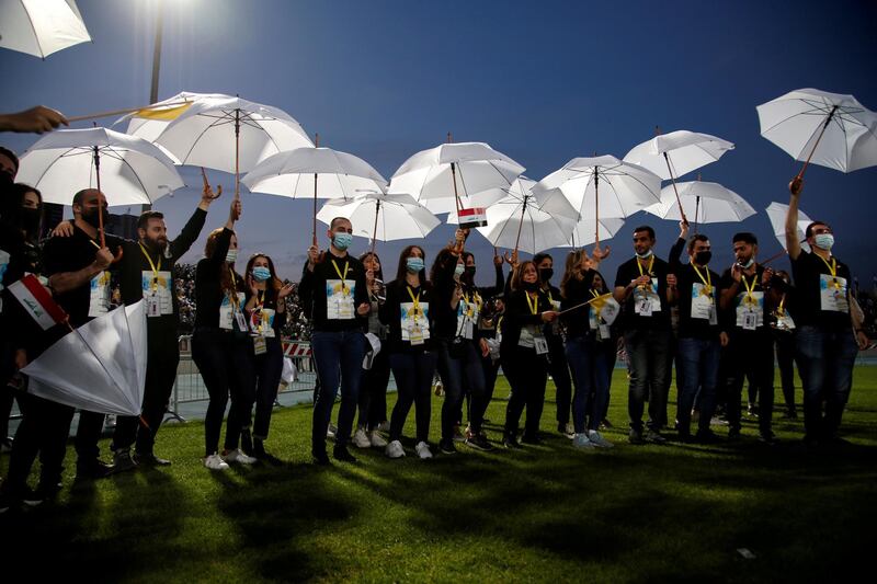 People carry umbrellas as they celebrate after a mass led by Pope Francis at the Franso Hariri Stadium in Erbil, Iraq. Reuters