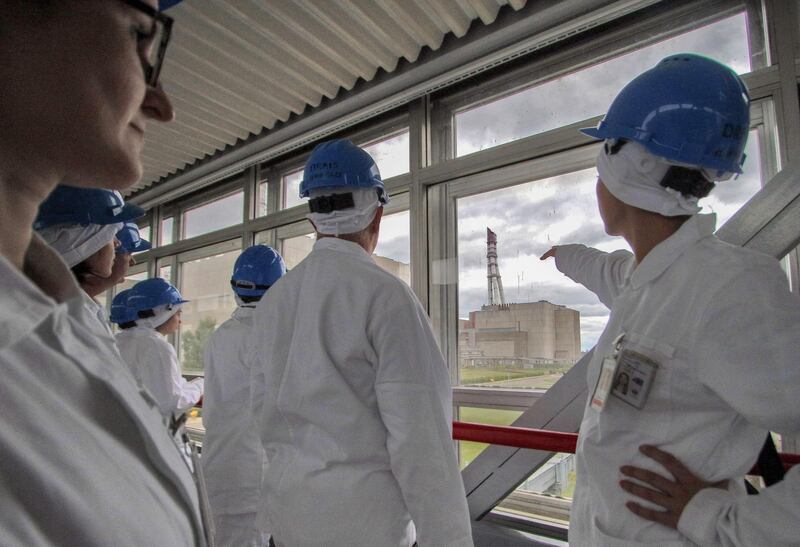 Tour guide Jurgita Norvaisiene points at the inoperative Ignalina nuclear power plant during a guided tour in Visaginas.