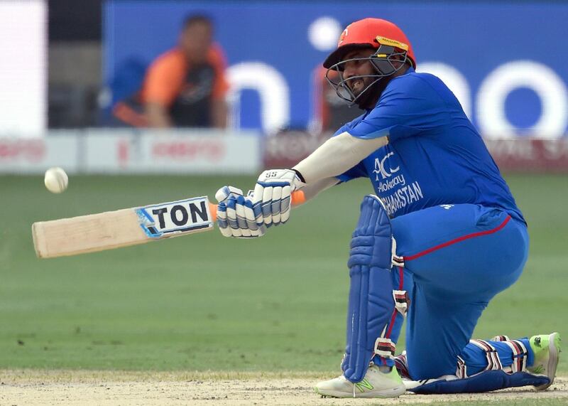 Afghan batsman Mohammad Shahzad plays a shot during the one day international (ODI) Asia Cup cricket match between Afghanistan and India at the Dubai International Cricket Stadium in Dubai on September 25, 2018. / AFP / Ishara S. KODIKARA
