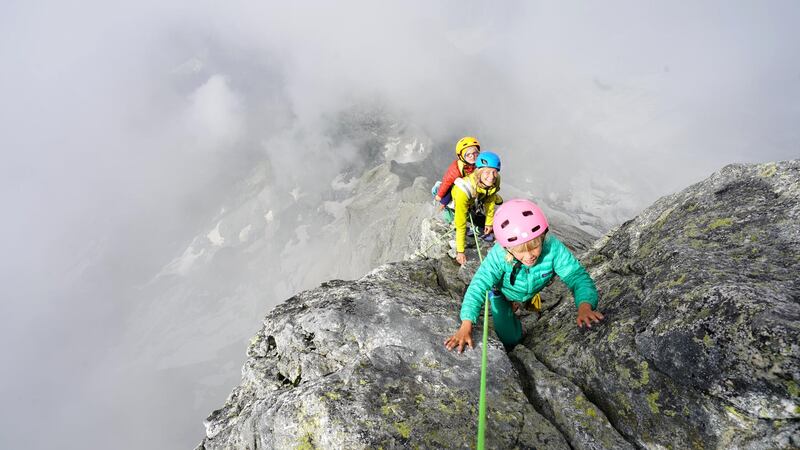 **Sent under embargo, no use before 14.00pm BST August 3 2020**
Freya Houlding with mum behind her on their three day trip to climb Piz Badile. See SWNS story SWPLclimb; A toddler and his seven-year-old sister have smashed records to become the youngest mountain climbers to scale a massive 10,000ft peak and were given a reward - of Haribo. Freya Houlding, seven, and three-year-old Jackson were literally following in their professional climber father's footsteps as he led them up Piz Badile on the border of Switzerland and Italy. Dad Leo Houlding, 40, spends his working life climbing some of the most dangerous and most remote mountains on earth, and his wife, 41-year-old Jessica, a GP, is an avid climber too. And now Freya has become the youngest person to climb the mountain unaided, and Jackson the youngest person to get to the top - 153 years to the day since the peak was first climbed. Jackon says he enjoyed his climb - and the sweets he got as a well done.