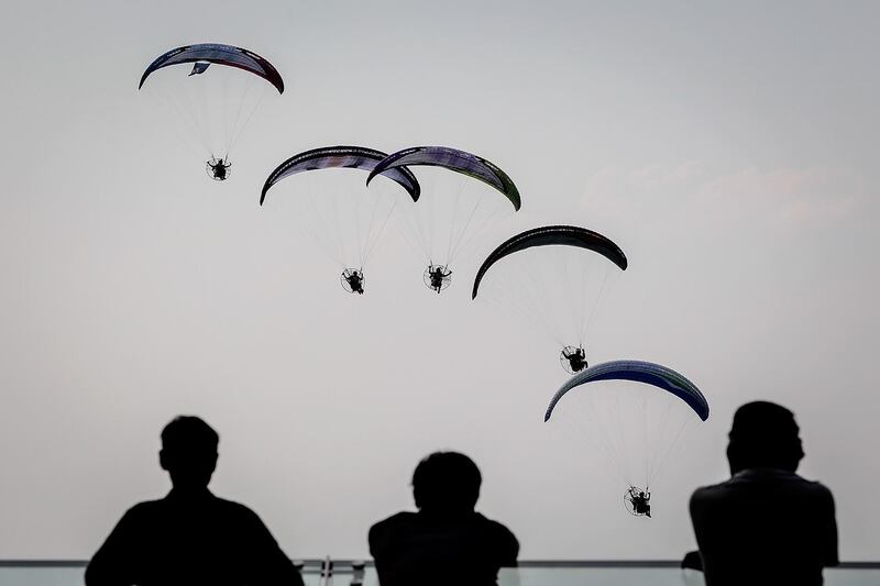 Tourists watch paragliders in Zhang Jiajie, Hunan Province,China.  Getty Images