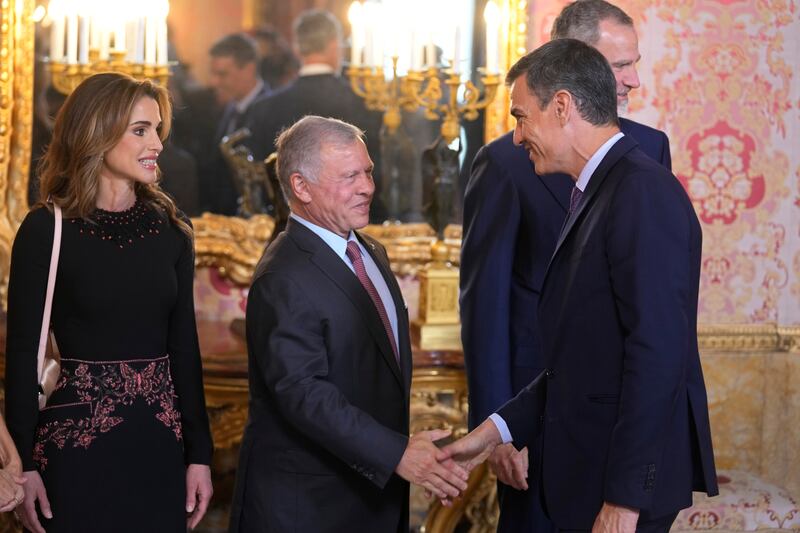 King Abdullah II shakes hands with Spain's Prime Minister Pedro Sanchez alongside Jordan's Queen Rania. AP