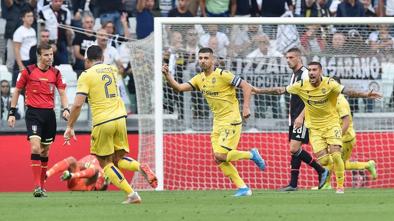 Hellas Verona's Miguel Veloso celebrates with his teammates after scoring to give his side the lead against Juventus. AFP