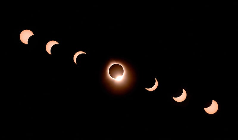 A composite of seven photographs showing the movement of the moon during the total solar eclipse as seen from Bloomington, Indiana. AFP