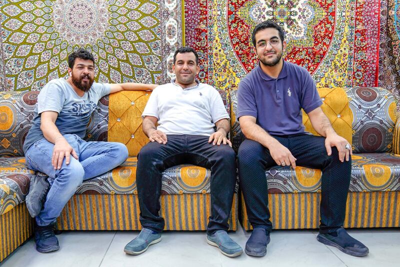 Abu Dhabi, United Arab Emirates, July 17, 2019.  Vendors of Al Mina Photo Project.  Al Mina Souk Market -- Dar Al Ain brothers, Kassem-42, Amir-36 and Saber-21.  These three brothers manage the Persian carpets and rug store, Dar Al Ain Furnishing at the Souk.
Victor Besa/The National
Section:  NA
Reporter:
