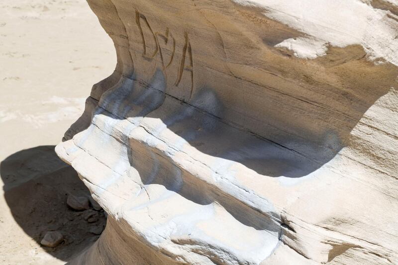 Abu Dhabi, United Arab Emirates - Graffiti vandalism near the entrance of the ancient rock formations attraction in the outskirts desert area, at Al Wathba. Khushnum Bhandari for The National