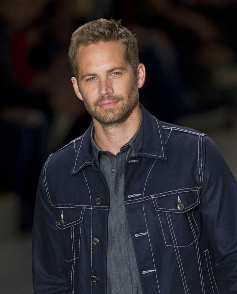FILE - This March 21, 2013 file photo shows U.S. actor Paul Walker wearing a creation from the Colcci summer collection at Sao Paulo Fashion Week in Sao Paulo, Brazil. A federal judge in Los Angeles ruled Monday, April 4, 2016, that the widow of Roger Rodas, the man who was driving the car that crashed and killed both him and Walker in 2013, had not shown evidence that the Porsche her husband was driving lacked safety features that would have prevented his death. (AP Photo/Andre Penner, File)