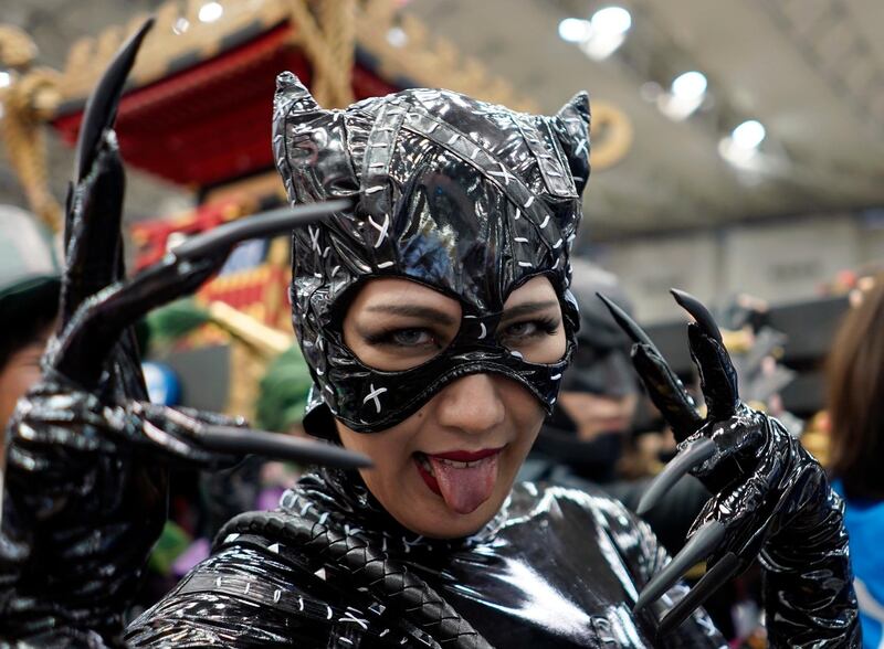 A cosplayer shows her tongue. EPA