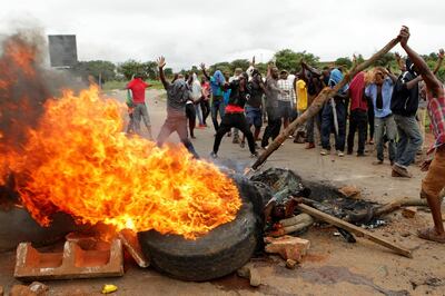 FILE - In this Tuesday, Jan. 15, 2019 file photo, protestors gather near a burning tire during a demonstration over the hike in fuel prices in Harare, Zimbabwe. 2019 is already a busy year for internet shutdowns in Africa, with governments ordering cutoffs as soon as a crisis appears. Zimbabwe ordered a â€œtotal internet shutdownâ€ in recent days during protests over a dramatic fuel price increase and a resulting deadly crackdown. (AP Photo/Tsvangirayi Mukwazhi, File)