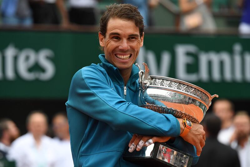 Spain's Rafael Nadal poses with the Mousquetaires Cup (The Musketeers) after his victory in the men's singles final match against Austria's Dominic Thiem, on day fifteen of The Roland Garros 2018 French Open tennis tournament in Paris on June 10, 2018. / AFP / Christophe ARCHAMBAULT
