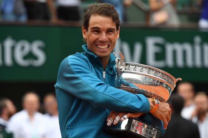 Spain's Rafael Nadal poses with the Mousquetaires Cup (The Musketeers) after his victory in the men's singles final match against Austria's Dominic Thiem, on day fifteen of The Roland Garros 2018 French Open tennis tournament in Paris on June 10, 2018. / AFP / Christophe ARCHAMBAULT
