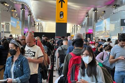 Travellers queue at security at Heathrow Airport in London. AP