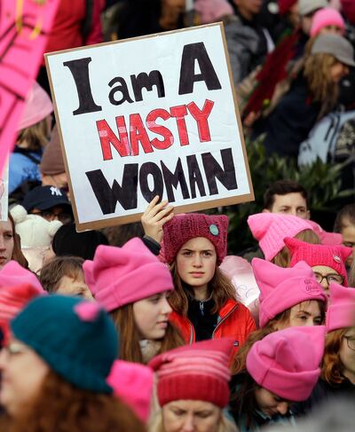 Women attend a rally in Seattle wearing the pink 'pussy hats' in protest. AP
