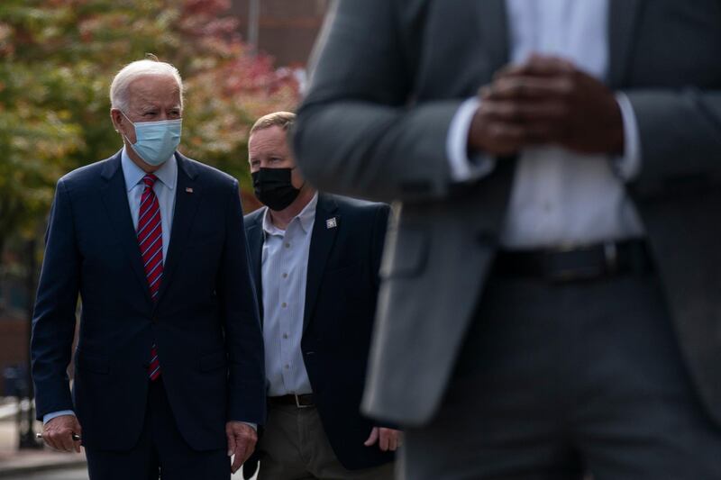 Democratic presidential candidate Joe Biden walks to his motorcade vehicle after talking with Wilmington, Delaware police officers as he departs The Queen theatre in Wilmington. AP Photo