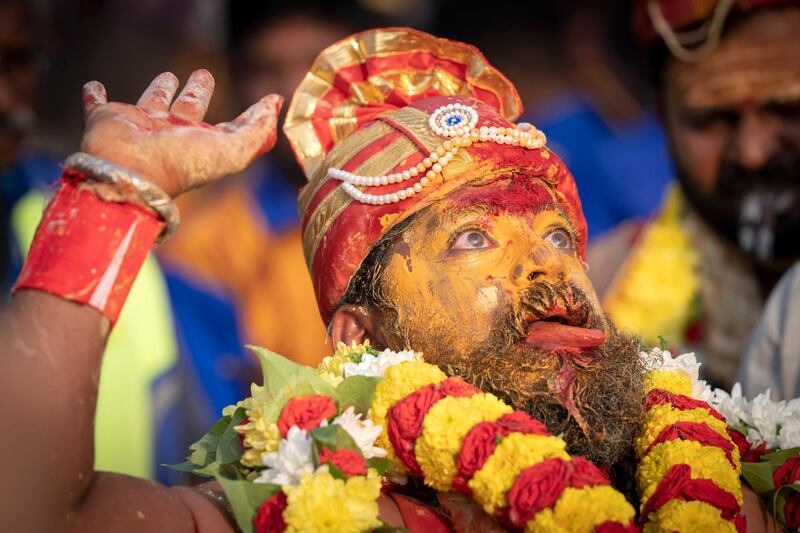 A Tamil Hindu priest has antiseptic powder on his face in a procession during the Thaipusam festival at Batu Caves, outskirts of Kuala Lumpur. AP Photo