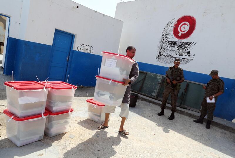 epa07841931 Workers of Tunisia's Independent High Election Authority (ISIE) are putting ballot boxes  in the polling station ahead of tomorrow's presidential election in Tunis, Tunisia, 14  September 2019.  EPA/MOHAMED MESSARA