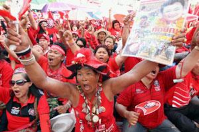 Supporters of the fugitive former Thai premier Thaksin Shinawatra in Red Shirts shout slogans during a mass rally on Ratchadamnoen road in Bangkok.