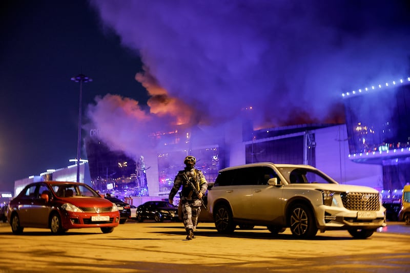Plumes of black smoke rise above Crocus City Hall after the attack. Reuters
