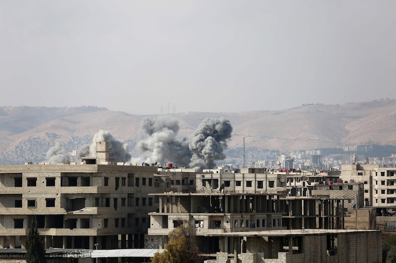 Smoke billows following a regime air strike on the rebel-held town of Haza, in the besieged Eastern Ghouta region on the outskirts of the capital Damascus, on February 23, 2018.
Syrian regime air strikes and artillery fire hit the rebel-held enclave of Eastern Ghouta for a sixth straight day killing 32 civilians, as the world struggled to reach a deal to stop the carnage. / AFP PHOTO / AMER ALMOHIBANY