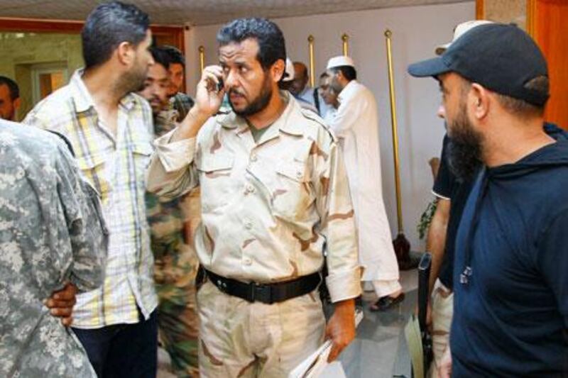 Abdel Hakim Belhaj, centre, is seen as a rebel military commander during the Libyan uprising in 2011. Belhaj and his wife are suing the British government, the former foreign secretary Jack Straw and the former head of the MI6 spy agency, Mark Allen. FRANCOIS MORI/AP